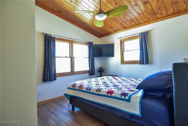 bedroom with dark hardwood / wood-style floors, ceiling fan, multiple windows, and vaulted ceiling