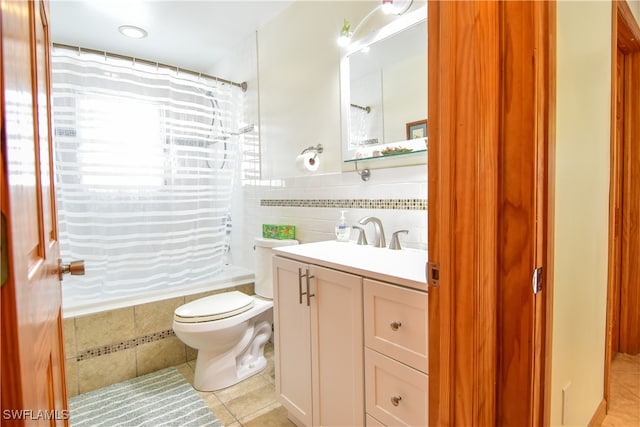 full bathroom with shower / bathtub combination with curtain, tile patterned flooring, toilet, vanity, and tile walls