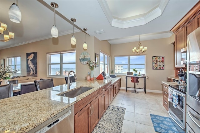 kitchen featuring a notable chandelier, light stone countertops, sink, and a wealth of natural light