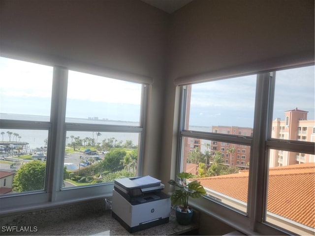 sunroom / solarium with plenty of natural light and a view of city