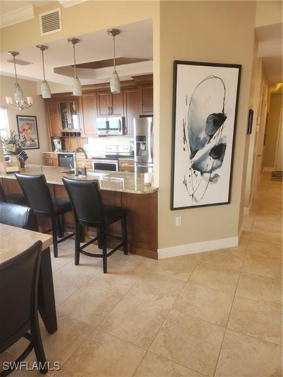 kitchen featuring stainless steel appliances, visible vents, brown cabinetry, glass insert cabinets, and pendant lighting