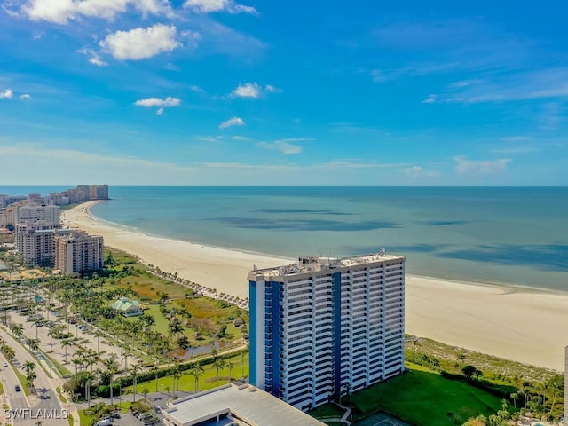 birds eye view of property featuring a water view and a beach view