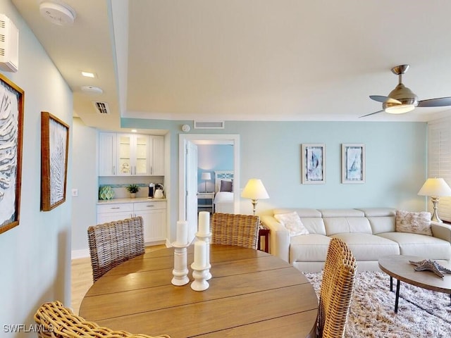 dining area with wood-type flooring and ceiling fan