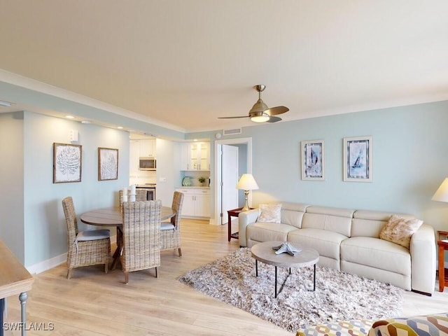 living room featuring ceiling fan and light wood-type flooring