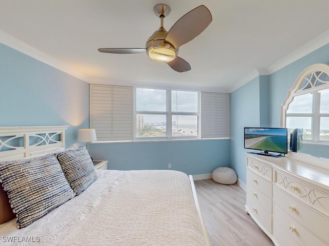 bedroom featuring ceiling fan, light hardwood / wood-style floors, and ornamental molding