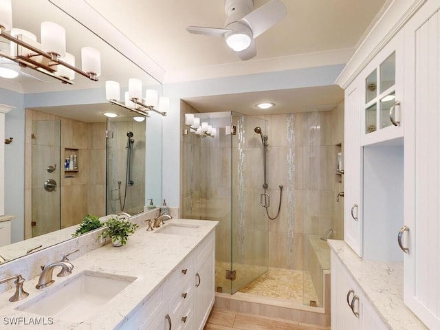 bathroom featuring ceiling fan, vanity, and an enclosed shower