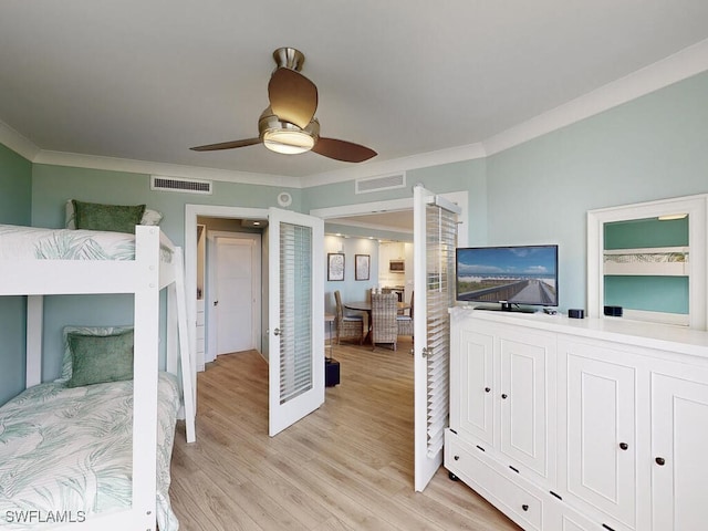 bedroom featuring ceiling fan, crown molding, and light wood-type flooring