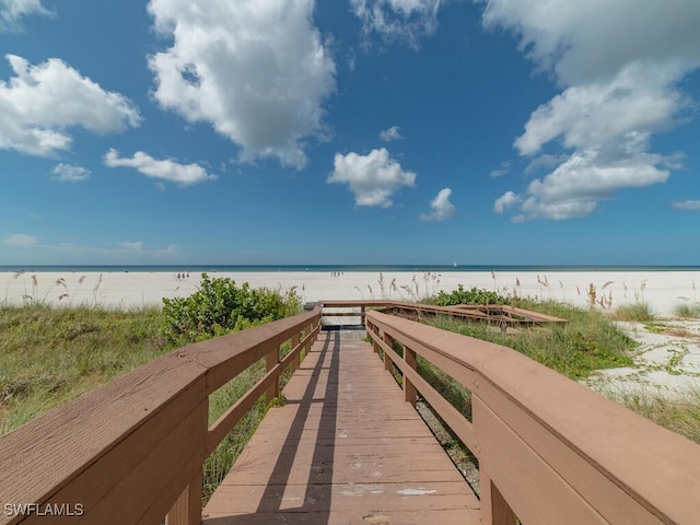 surrounding community featuring a view of the beach and a water view