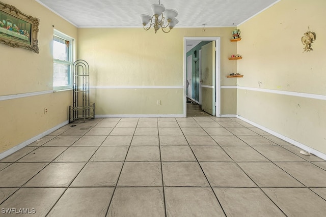 unfurnished room featuring light tile patterned floors, crown molding, and a notable chandelier