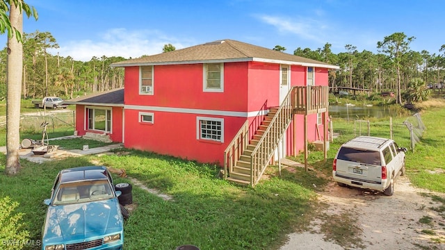 rear view of house featuring a water view