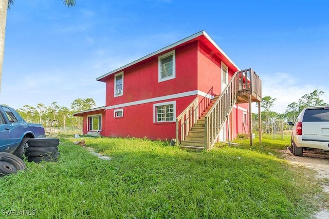 10010 Saint Paul Rd, North Fort Myers, FL 33917 - view of property exterior featuring stairway, stucco siding, and a deck