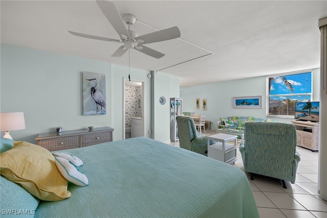 bedroom featuring ceiling fan, light tile patterned floors, and connected bathroom