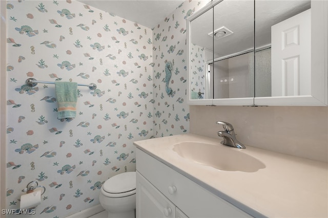 bathroom featuring toilet and vanity