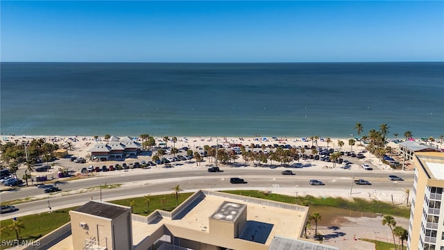 birds eye view of property featuring a water view and a beach view