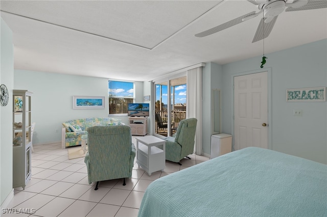 tiled bedroom featuring ceiling fan, access to exterior, and a wall of windows