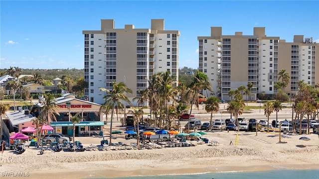 view of property with a water view and a view of the beach