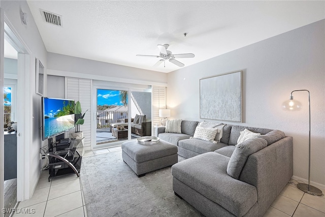 living room featuring ceiling fan and light tile patterned floors