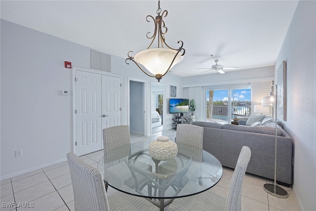 dining space featuring light tile patterned floors and ceiling fan