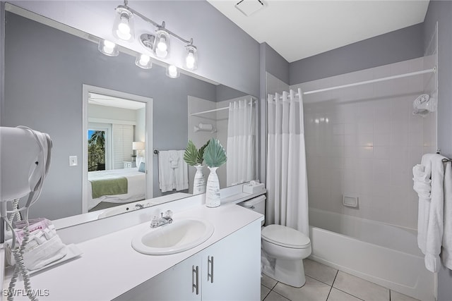 full bathroom featuring tile patterned flooring, vanity, toilet, and shower / bath combo with shower curtain