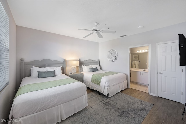 bedroom featuring hardwood / wood-style floors, ceiling fan, and connected bathroom