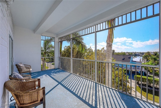 sunroom / solarium featuring beam ceiling