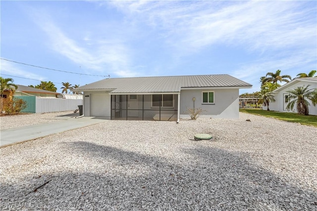 rear view of property with a sunroom