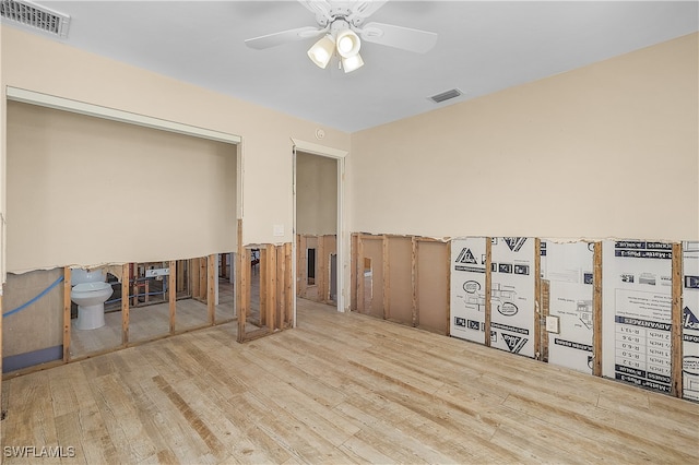 unfurnished room with light wood-type flooring and ceiling fan