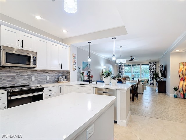 kitchen with sink, ceiling fan, decorative light fixtures, white cabinetry, and stainless steel appliances