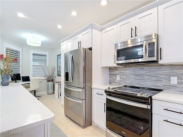 kitchen featuring backsplash, white cabinetry, light tile patterned floors, and appliances with stainless steel finishes