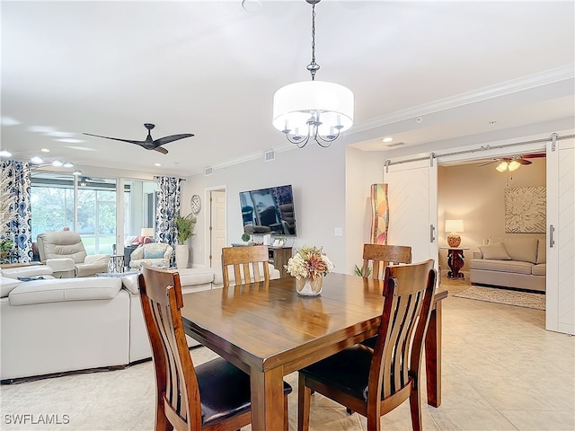 tiled dining space with a barn door, ceiling fan with notable chandelier, and ornamental molding