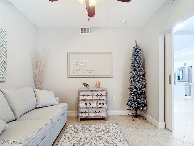 sitting room with tile patterned floors and ceiling fan