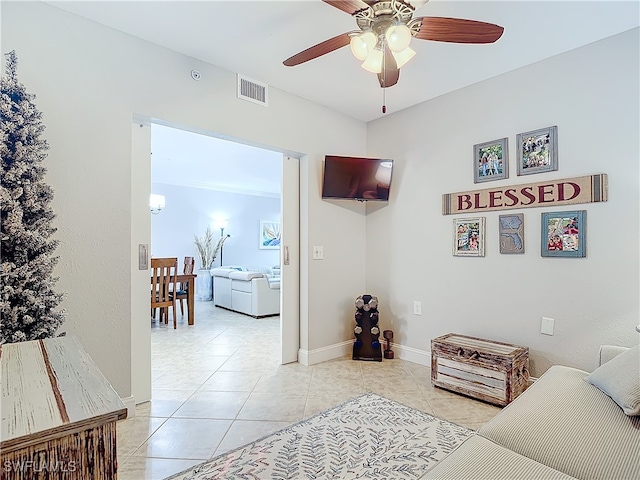 living room featuring ceiling fan and light tile patterned flooring