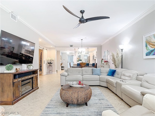 tiled living room with ceiling fan with notable chandelier and ornamental molding