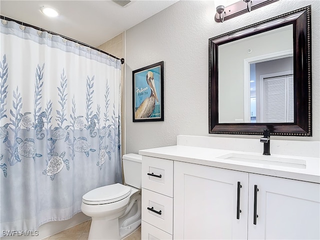 bathroom featuring toilet, vanity, tile patterned floors, and curtained shower