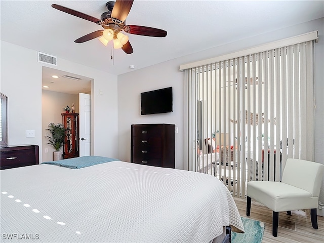 bedroom featuring access to outside, ceiling fan, and light hardwood / wood-style floors