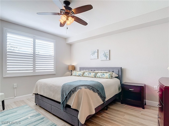 bedroom with ceiling fan and light hardwood / wood-style floors