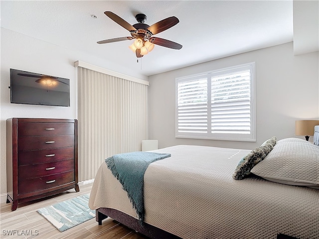 bedroom with ceiling fan and light hardwood / wood-style floors