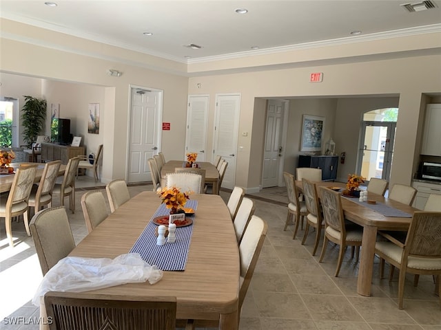 dining area featuring crown molding