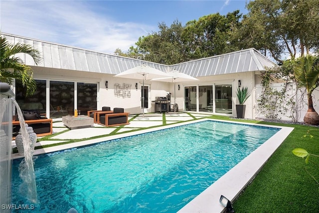 rear view of property with pool water feature, an outdoor hangout area, and a patio area