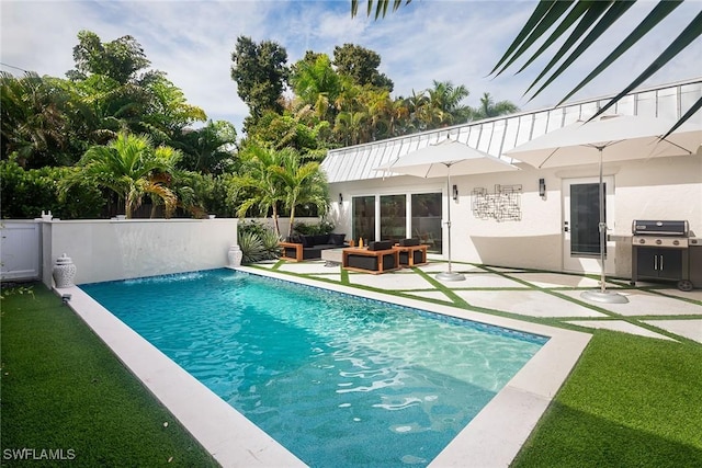 view of swimming pool with outdoor lounge area, area for grilling, and a patio