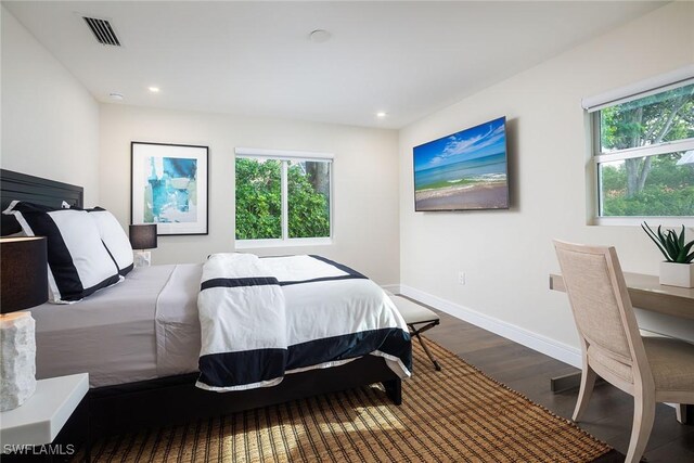 bedroom with dark hardwood / wood-style floors