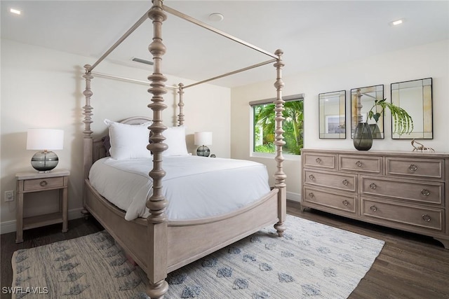 bedroom with dark hardwood / wood-style floors