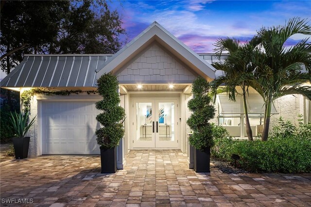 view of front facade featuring a garage and french doors