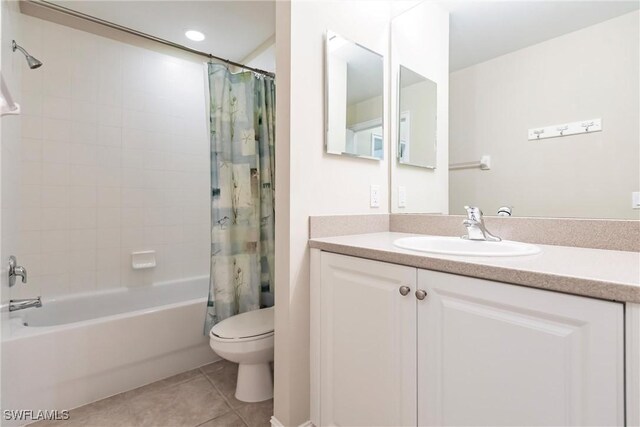 full bathroom featuring shower / bath combo with shower curtain, tile patterned flooring, vanity, and toilet