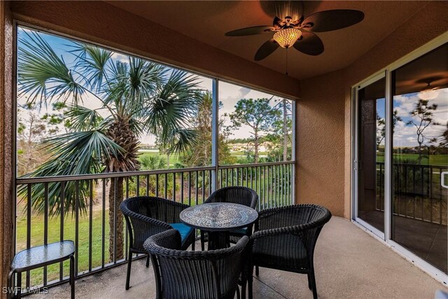 sunroom featuring ceiling fan