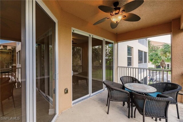 sunroom / solarium featuring ceiling fan