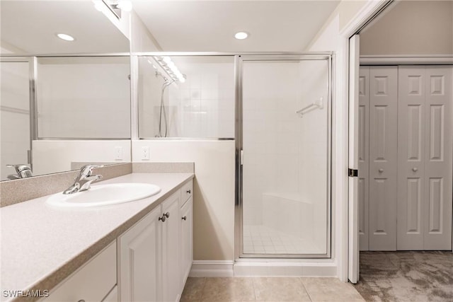 bathroom with vanity, tile patterned floors, and a shower with shower door