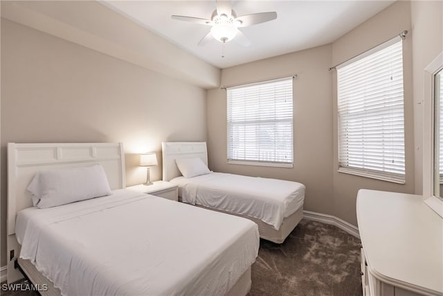 bedroom featuring dark colored carpet and ceiling fan