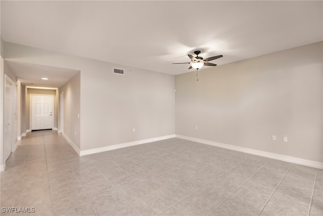 empty room featuring ceiling fan and light tile patterned flooring