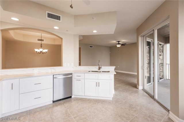 kitchen featuring pendant lighting, sink, white cabinetry, ceiling fan with notable chandelier, and stainless steel dishwasher